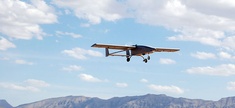 A TigerShark unmanned aerial vehicle descends to land at an undisclosed location following a mission. 