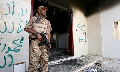 A Libyan military guard stands in front of one of the U.S. Consulate's burnt out buildings.