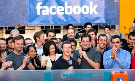 Facebook founder, Chairman and CEO Mark Zuckerberg, center, rings the opening bell of the Nasdaq stock market after his company priced its IPO.