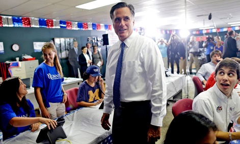 Mitt Romney greets volunteers at his campaign headquarters in Jacksonville, Fla.