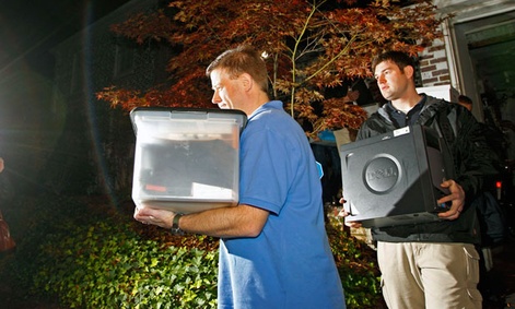 FBI agents carry computers and boxes of printed documents from Paula Broadwell's home Tuesday.