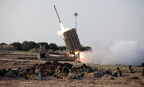 Israeli soldiers lie on the ground as an Iron Dome missile is launched near the city of Ashdod, Israel, Monday Nov 19. 2012.