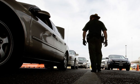 A CBP agent checks traffic leaving the U.S. for Mexico in Laredo, Texas. 