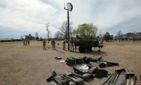 Marines set up a M142C radio attached to the Tactical Elevated Antennae Mast System antenna during a training exercise held aboard Camp Lejeune, N.C., in 2010. 