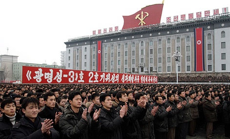 North Koreans applaud near a slogan which reads “(we) fervently celebrate the successful launch of the second version of the Kwangmyongsong-3 satellite 2nd version" during a mass rally in Pyongyang. North Koreans applaud near a slogan which reads “(we) fervently celebrate the successful launch of the second version of the Kwangmyongsong-3 satellite 2nd version" during a mass rally in Pyongyang.