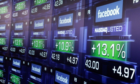 Electronic screens show the price of Facebook shares after they began trading Friday, May 18, 2012 in New York.