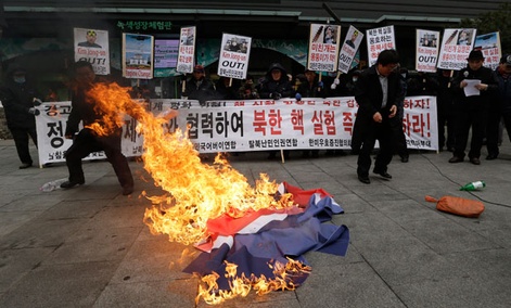 South Korean protesters burn a North Korean flag during an anti-North Korea rally in Seoul Tuesday.