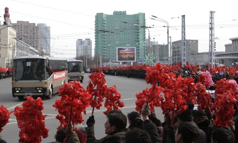 Buses carrying North Korean nuclear scientists was greeted when it arrived in Pyongyang Wednesday.