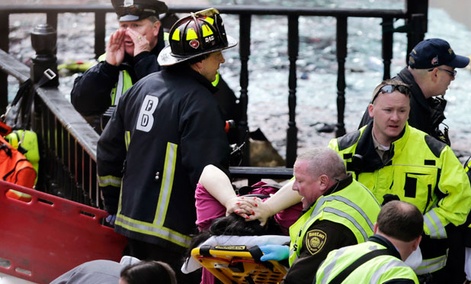 Workers aid an injured woman at the scene of the blast Monday Workers aid an injured woman at the scene of the blast Monday