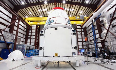 The SpaceX Dragon spacecraft inside a processing hangar at Cape Canaveral Air Force Station in Cape Canaveral, Fla. The SpaceX Dragon spacecraft inside a processing hangar at Cape Canaveral Air Force Station in Cape Canaveral, Fla.