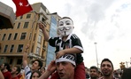 A boy on a man's shoulders wears a Guy Fawkes mask during the third day of anti-government protests in Istanbul. 