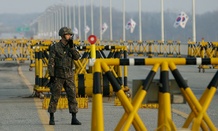 A South Korean soldier uses his radio at Unification Bridge.