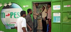 Customers make money transfers at an M-Pesa counter in Nairobi, Kenya. A mobile banking service, M-Pesa allows people without a bank account to transfer money between phones instantly.
