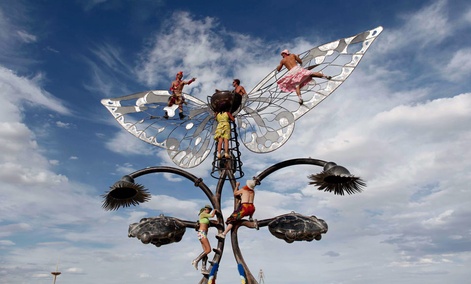 Burning Man participants reach for the skies in a different way, by climbing on an art structure during the festival. Burning Man participants reach for the skies in a different way, by climbing on an art structure during the festival.