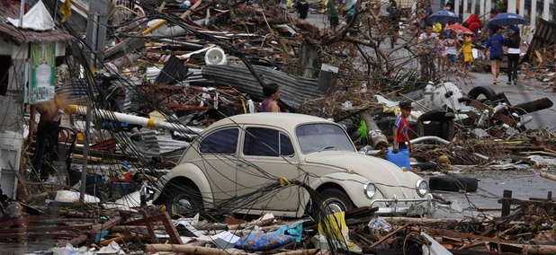 People search through debris in the Leyte province Tuesday. People search through debris in the Leyte province Tuesday.