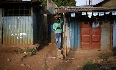 A man checks his phone in Nairobi, Kenya. A man checks his phone in Nairobi, Kenya.
