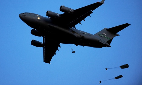 Paratroopers jump from a C-17 in an exercise. Paratroopers jump from a C-17 in an exercise.