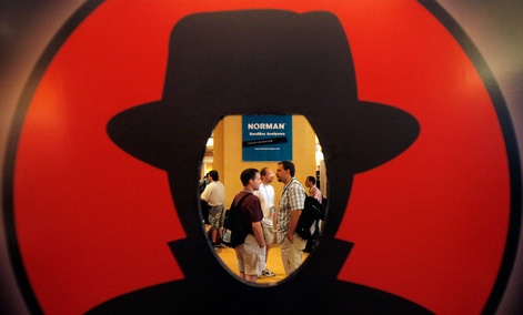 Attendees are seen through a Black Hat logo during the Black Hat and Defcon hacker conferences in Las Vegas. Attendees are seen through a Black Hat logo during the Black Hat and Defcon hacker conferences in Las Vegas.