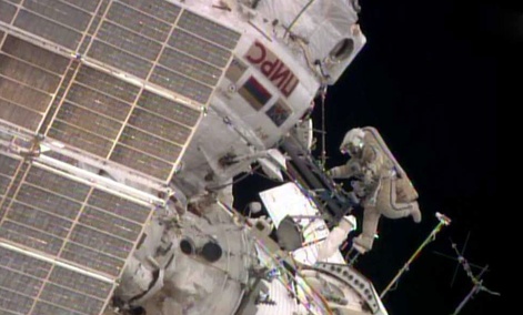 While Flight Engineer Alexander Skvortsov retrieves hardware inside the International Space Station's Pirs airlock, Flight Engineer Oleg Artemyev stretches his legs. While Flight Engineer Alexander Skvortsov retrieves hardware inside the International Space Station's Pirs airlock, Flight Engineer Oleg Artemyev stretches his legs.