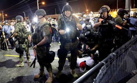 A man is arrested as police try to disperse a crowd during protests in Ferguson, Mo. A man is arrested as police try to disperse a crowd during protests in Ferguson, Mo.