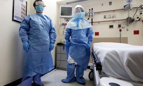 Bellevue Hospital nurse Belkys Fortune, left, and Teressa Celia, Associate Director of Infection Prevention and Control, pose in protective suits in the Emergency Room, during a demonstration of procedures for possible Ebola patients. Bellevue Hospital nurse Belkys Fortune, left, and Teressa Celia, Associate Director of Infection Prevention and Control, pose in protective suits in the Emergency Room, during a demonstration of procedures for possible Ebola patients.