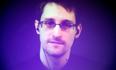 Former U.S. National Security Agency contractor Edward Snowden, who is in Moscow, is seen on a giant screen during a live video conference for an interview with Amnesty International. Former U.S. National Security Agency contractor Edward Snowden, who is in Moscow, is seen on a giant screen during a live video conference for an interview with Amnesty International.