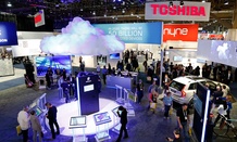 People walk through the Ericsson booth during the International CES Friday, Jan. 9, 2015, in Las Vegas. 