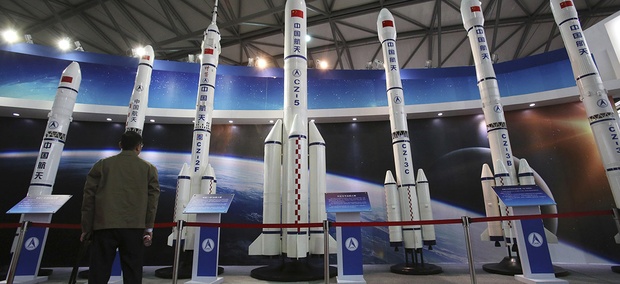 A visitor looks at the scale models of Chinese space rockets displayed at the China International Industry Fair in Shanghai, China. A visitor looks at the scale models of Chinese space rockets displayed at the China International Industry Fair in Shanghai, China.