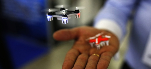 A man controls a mini drone during the Global Robot Expo fair in Madrid, Thursday, Jan. 28, 2016. A man controls a mini drone during the Global Robot Expo fair in Madrid, Thursday, Jan. 28, 2016.