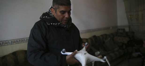 Iraqi special forces Lt. Col. Ali Hussein holds a destroyed drone used by Islamic State militants, which was shot down by his brigade, in the Bakr front line neighborhood, in Mosul, Iraq, Friday Nov. 25, 2016. Iraqi special forces Lt. Col. Ali Hussein holds a destroyed drone used by Islamic State militants, which was shot down by his brigade, in the Bakr front line neighborhood, in Mosul, Iraq, Friday Nov. 25, 2016.