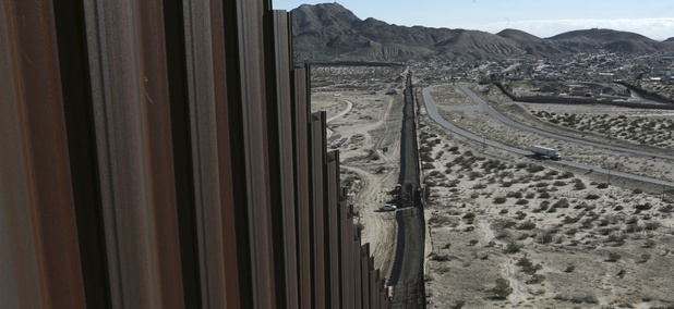 A truck drives near the Mexico-US border fence. A truck drives near the Mexico-US border fence.