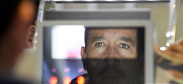 A pedestrian crossing from Mexico into the United States at the Otay Mesa port of entry has his facial features and eyes scanned at a biometric kiosk Thursday, Dec. 10, 2015, in San Diego. A pedestrian crossing from Mexico into the United States at the Otay Mesa port of entry has his facial features and eyes scanned at a biometric kiosk Thursday, Dec. 10, 2015, in San Diego.