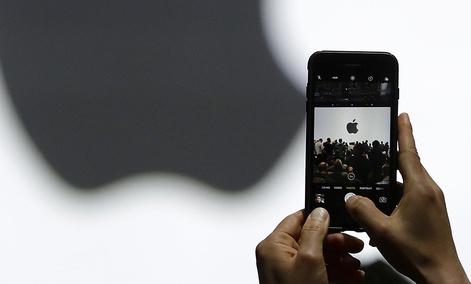 A person takes a photo of an Apple logo before an announcement of new products at the Apple Worldwide Developers Conference on June 5, 2017. A person takes a photo of an Apple logo before an announcement of new products at the Apple Worldwide Developers Conference on June 5, 2017.