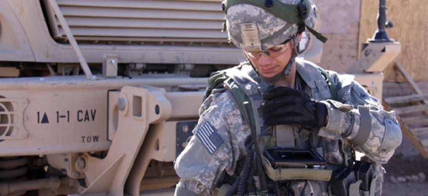 A soldier uses a JTRS Rifleman Radio during a network evaluation exercise in 2011. 