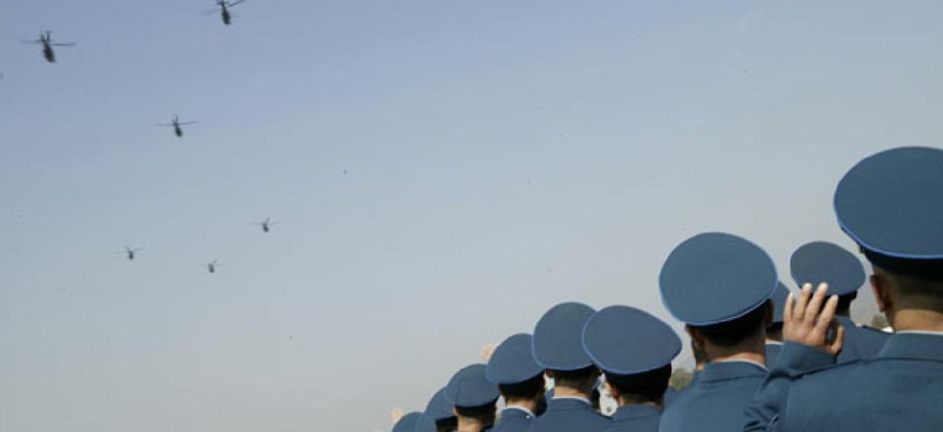 Chinese People's Liberation Army Air Force officers watch helicopters during a celebration.