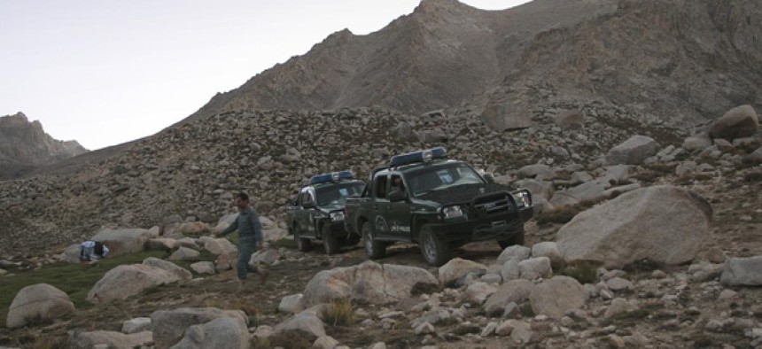 Afghan police patrol mountains outside Kabul.