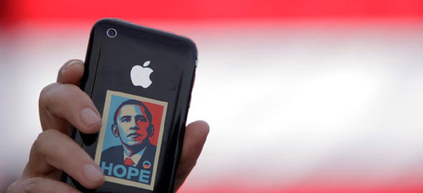 An Obama supporter holds up an iPhone during a 2008 rally.