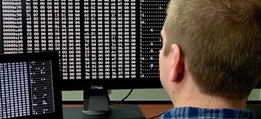 A cybersecurity analyst looks at code in the Homeland Security Department's malware laboratory.
