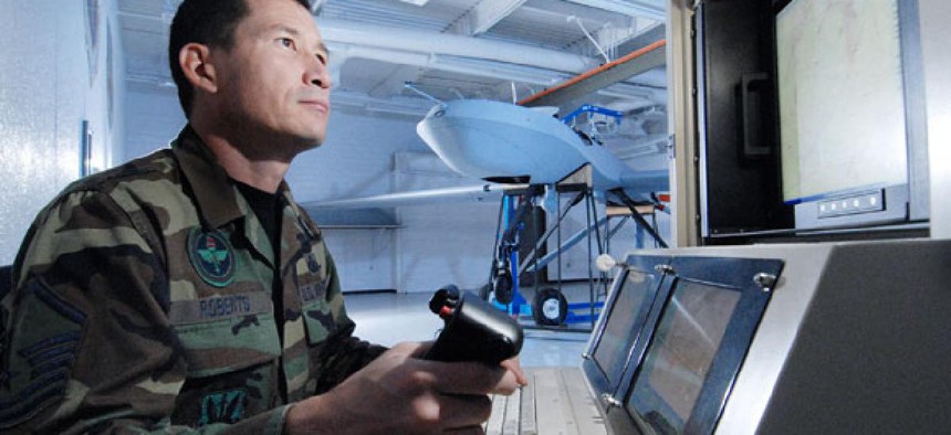 Master Sgt. Fred Roberts uses a maintenance interface station to check an MQ-1 Predator unmanned aircraft.