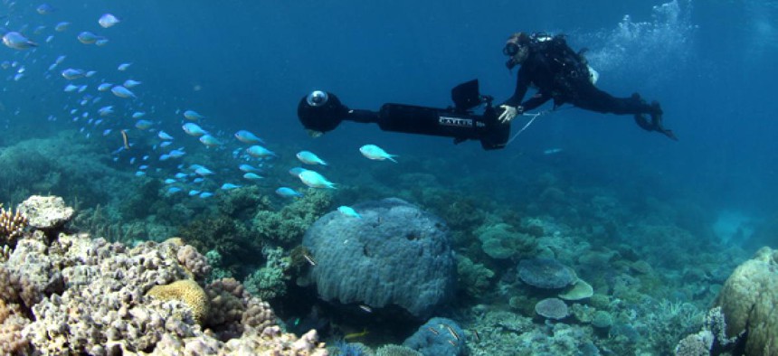 A team member of the Catlin Seaview Survey works to capture the Great Barrier Reef.