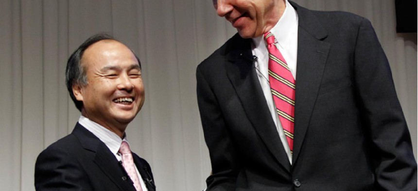 Softbank Corp. President Masayoshi Son, left, and Sprint Nextel Corp. Chief Executive Dan Hesse shake hands.