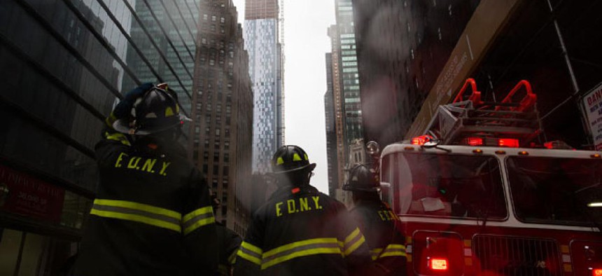 Firefighters respond to a call during the storm in New York Monday.