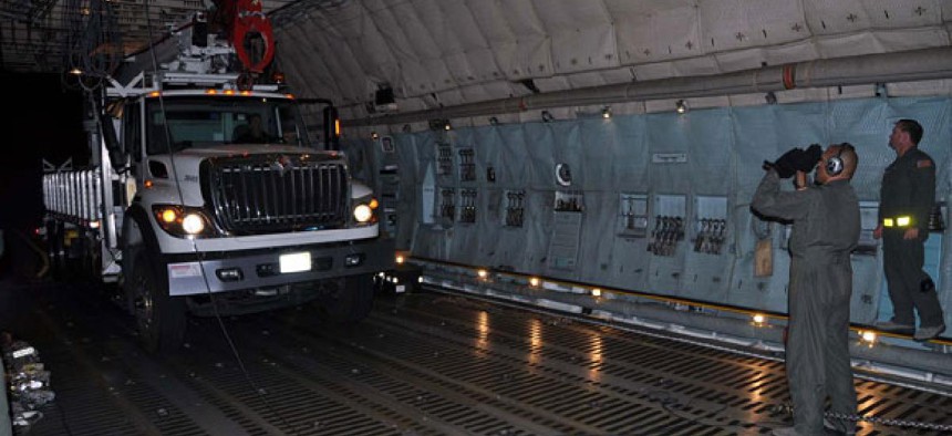 Reservists and technicians from March Air Reserve Base, Calif., load electrical equipment into a transport aircraft to send to the East Coast after the storm.