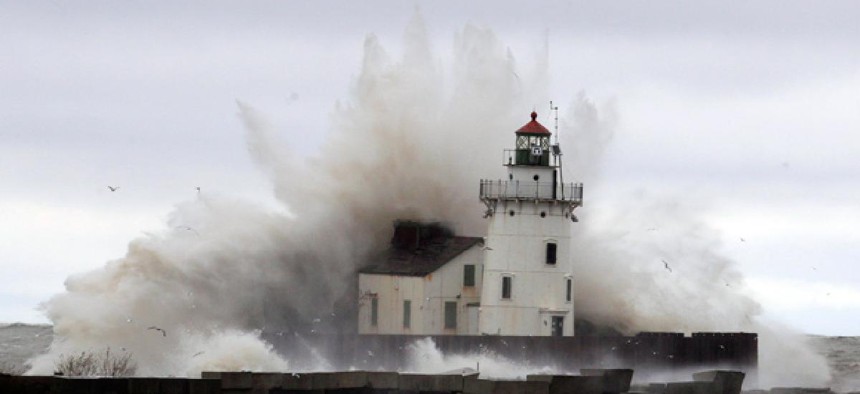 Waves pound a lighthouse as Hurricane Sandy hits the shores of Lake Erie, Tuesday.