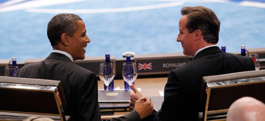 Obama and Cameron commiserate during a NATO meeting in May.