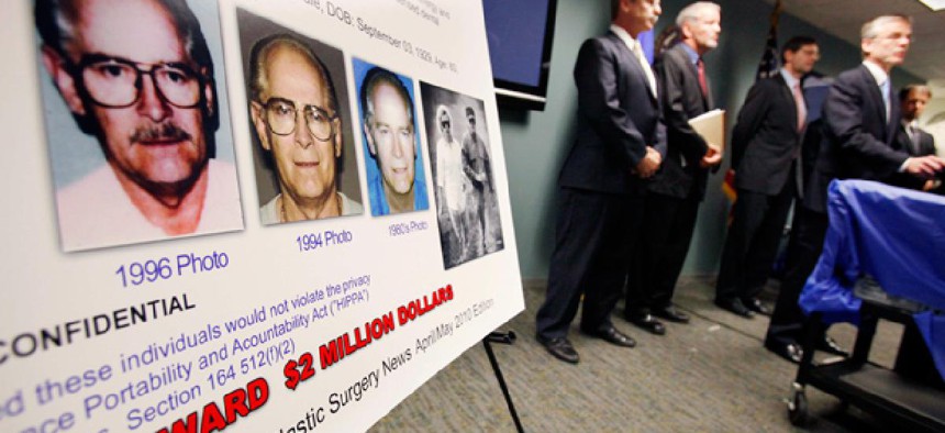 FBI special agent Richard Deslauriers, right, speaks during a news conference about their hunt for fugitives James "Whitey" Bulger and Catherine Greig in 2011.  The FBIs facial recognition app would help identify criminal suspects in the field.