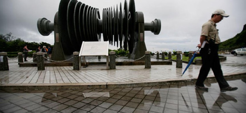 A security officer in 2011 walks past a low-pressure turbine rotor at an atomic energy site in Taiwan's Wanli district.