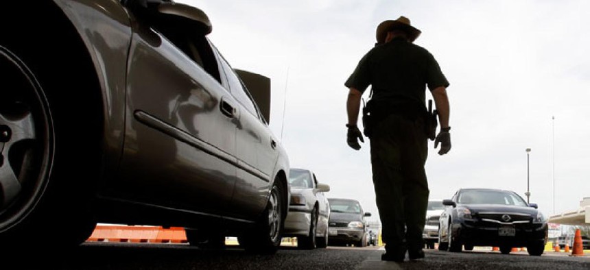 A CBP agent checks traffic leaving the U.S. for Mexico in Laredo, Texas. 
