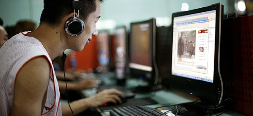 A visitor at an Internet cafe in Beijing surfs the web.