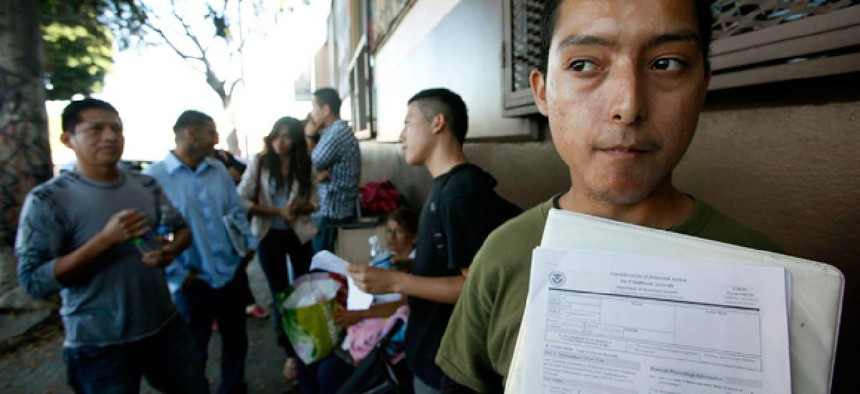 Illegal immigrant Layios Roberto waits with papers outside the offices of Coalition for Humane Immigrant Rights in Los Angeles Wednesday, Aug. 15, 2012.